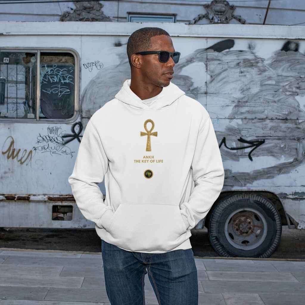 Adult black male model wearing a White personalised hoodie, with a large gold Ankh symbol on the centre of the hoodie, with the words Ankh, The Key of Life with a small BTMR Round Logo underneath. Model has his hand in his pockets, and is wearing sunglasses