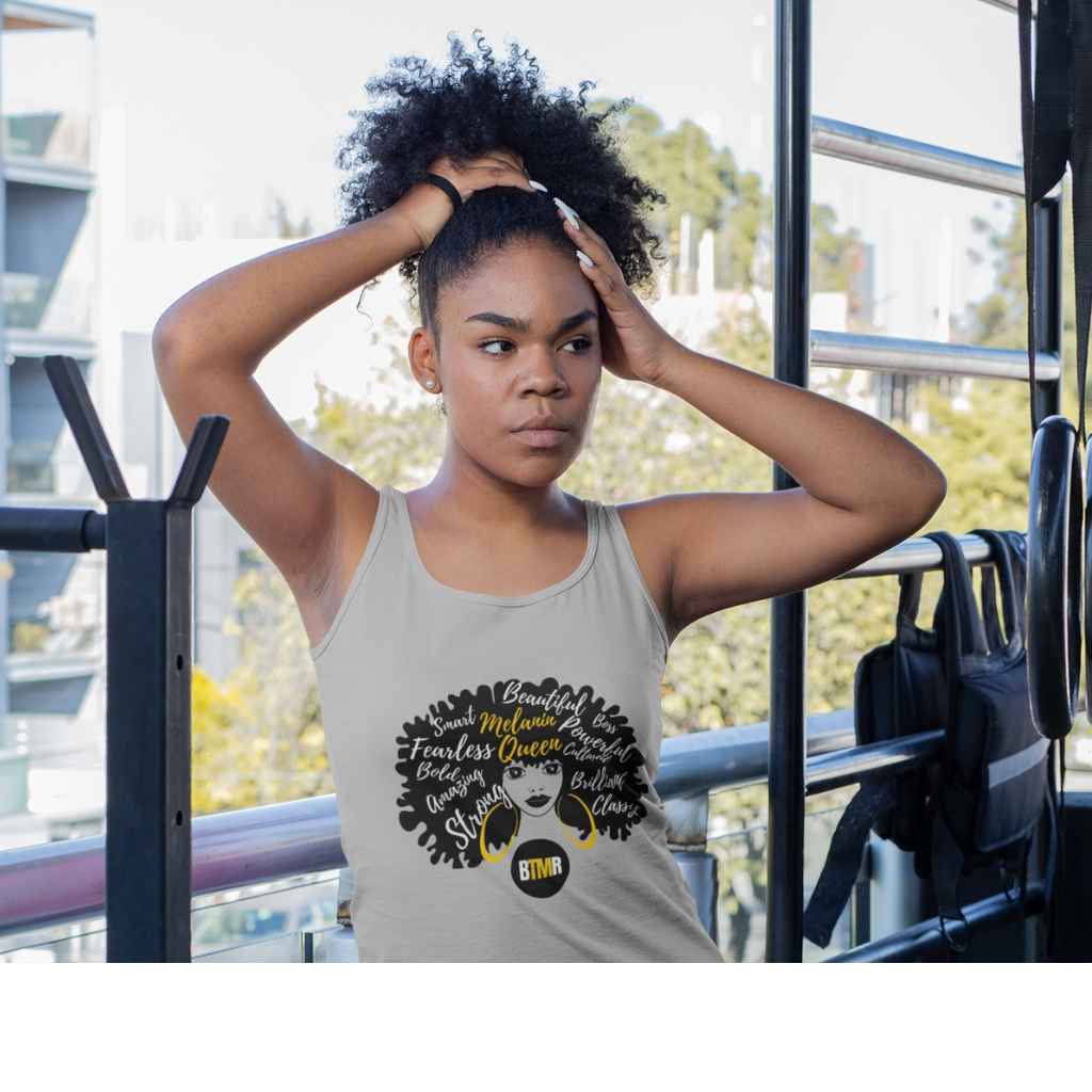 BlackToMyRoots Melanin Queen Grey Tank top worn by a black young women in a gym. T Shirt features a design of a Black Woman silhouette with a large natural afro, which has positive words embedded in the afro. Underneath is the BlackToMyRoots logo - a solid black circle with the initials BTMR in the centre. Model is about to put her hair into a bunch. - 