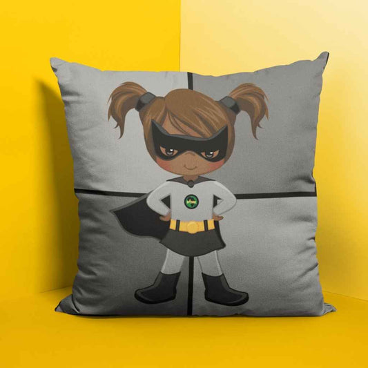 Square scatter cushion with a large picture of a black superheroine dressed in grey. The superheroine has a black mask covering her eyes and her hands are on her hips. The cushion is divided into quarters, The cushion is against a bright yellow background