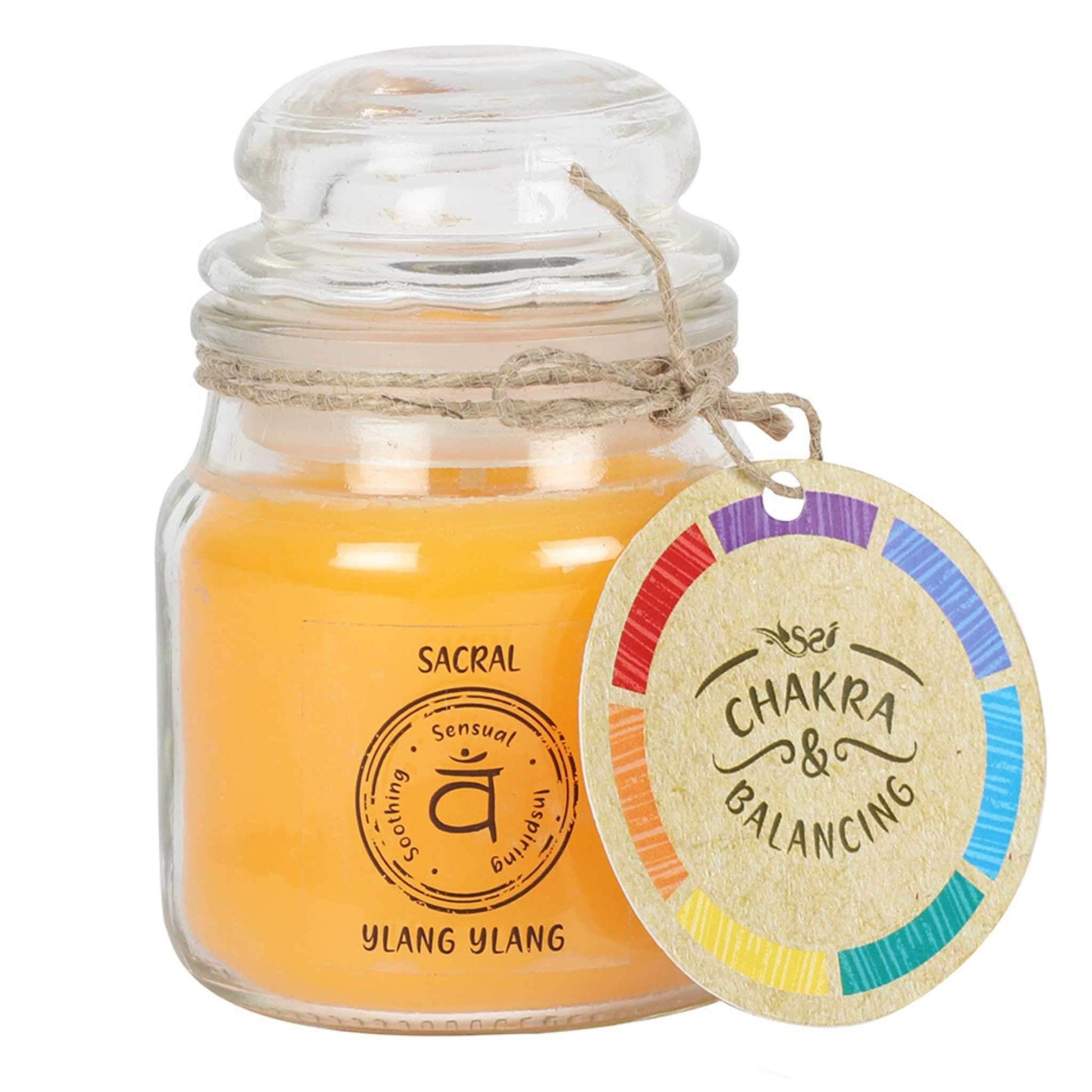 Balancing Chakra Candle in a min glass jar with stopper. Tied with a label that says Chakra Balancing. Candle is orangey yellow with a label on the jar that says Sacral - Ylang Ylang