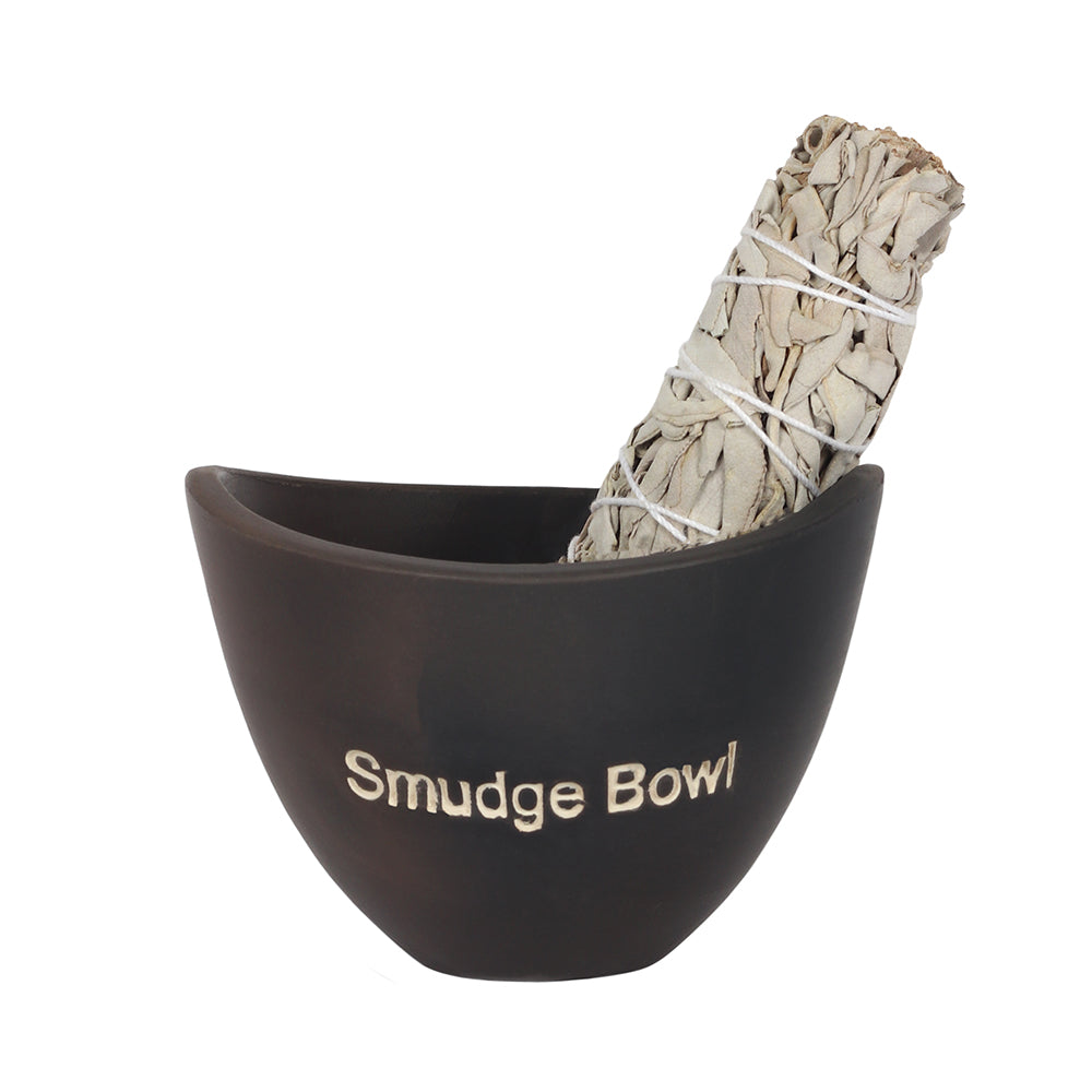 Smudge stick in a small black smudge bowl. The smudge stick is unlit. The smudge bowl has the words Smudge Bowl etched into the front of the bowl. 